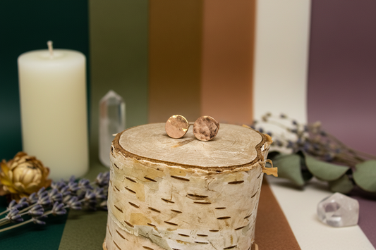 Copper Glow Studs by Jewellery by JN, hammered copper circles with sterling silver posts, shown straight on against a creamy background.