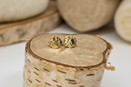 close-up of Golden Charm Studs by Jewellery by JN, highlighting hammered brass and silver post detail.