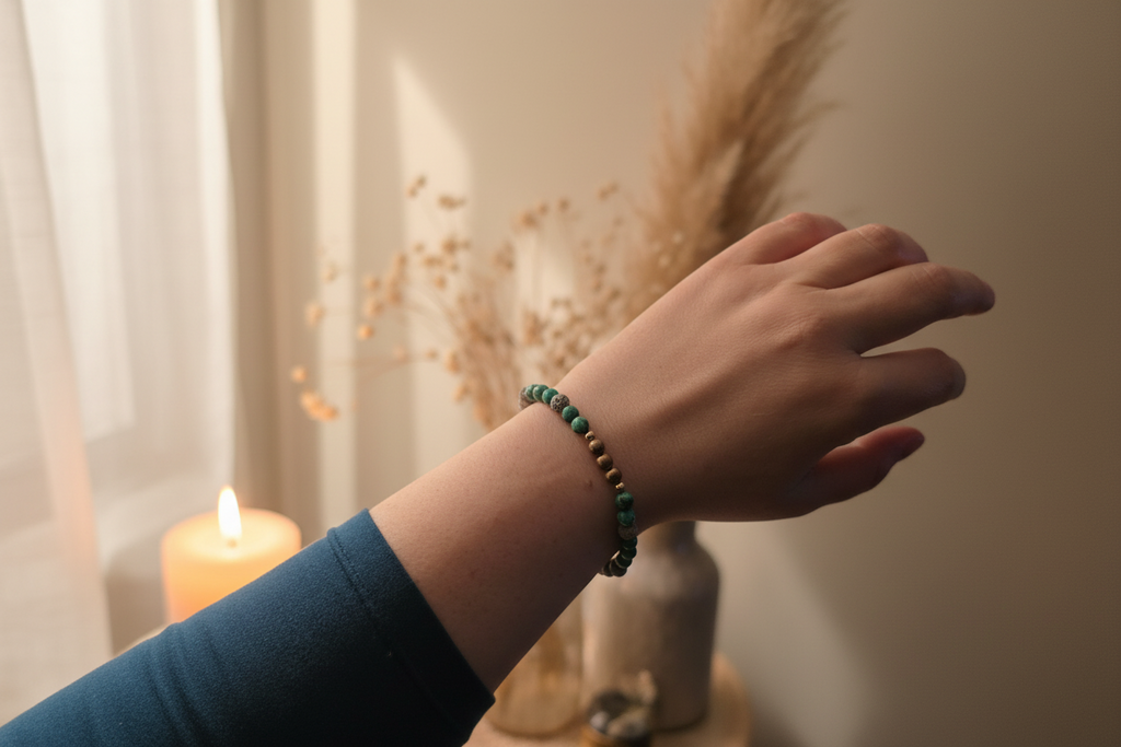 Woman’s wrist wearing the Wayfinder Bracelet by Jewellery by JN, with African turquoise, grey lava rock, and sterling silver beads.