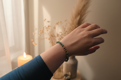 Woman’s wrist wearing the Wayfinder Bracelet by Jewellery by JN, with African turquoise, grey lava rock, and sterling silver beads.