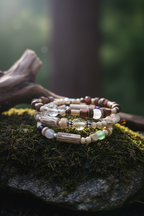 Stack of beaded bracelets on a rock with a natural background