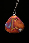 A teardrop-shaped pendant necklace with a cutout Norse letter 'M' design, featuring a textured copper and purple iridescent finish, suspended on a black background.