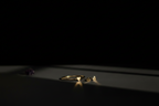 A minimalist jewelry display featuring a gold ring and matching small gold earrings on a dark surface, with dramatic spotlighting against a solid black background.