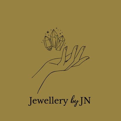 Logo of 'Jewellery by JN' featuring a hand holding crystals on a beige background.