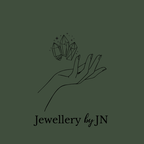 Logo of 'Jewellery by JN' featuring a hand holding crystals on a beige background.