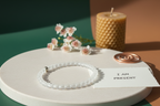 Lumenveil Bracelet by Jewellery by JN with handwritten affirmation card, styled with ritual props on a creamy background.