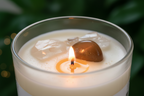 Close-up of Manifestation Intention Candle by Jewellery by JN, highlighting Clear Quartz, Tiger's Eye, sage, and silver and gold glitter.