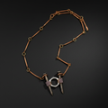 A unique jewelry piece featuring a copper-toned chain with circular and linear links, terminating in two silver-toned spikes resembling nails, each wrapped with a textured purple band and connected by a silver-toned ring.