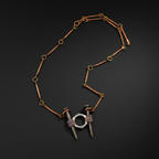 A unique jewelry piece featuring a copper-toned chain with circular and linear links, terminating in two silver-toned spikes resembling nails, each wrapped with a textured purple band and connected by a silver-toned ring.