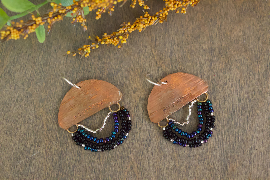 Mini Wordkeeper Earrings Protected by Jewellery by JN, hand-forged copper, bead fringe in black and silver, single PROTECTED affirmation, sterling silver hooks