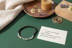 Shadowseer Bracelet by Jewellery by JN with handwritten affirmation card, styled with ritual props on a creamy background.