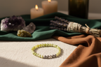 Stonecloak Bracelet styled with ritual props, featuring Canadian jade, grey volcanic rock, and a silver accent bead, Jewellery by JN.
