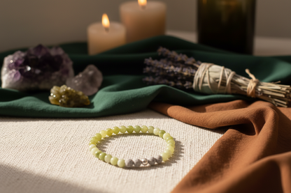 Stonecloak Bracelet styled with ritual props, featuring Canadian jade, grey volcanic rock, and a silver accent bead, Jewellery by JN.