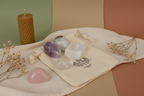 Full Moon Gemstone Bag by Jewellery by JN, recycled cotton pouch with tumbled Moonstone, Amethyst, Selenite, and Clear Quartz, displayed on creamy linen with ritual props.