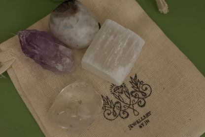 Close-up of tumbled gemstones from Full Moon Gemstone Bag by Jewellery by JN, showing Moonstone, Amethyst, Selenite, and Clear Quartz.