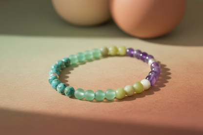 Multicolored beaded bracelet on a beige surface with a soft focus background