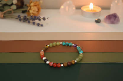 Elder Fire Bracelet styled with ritual props, featuring red agate, jade, jasper, turquoise, amethyst, obsidian, and silver beads, Jewellery by JN.