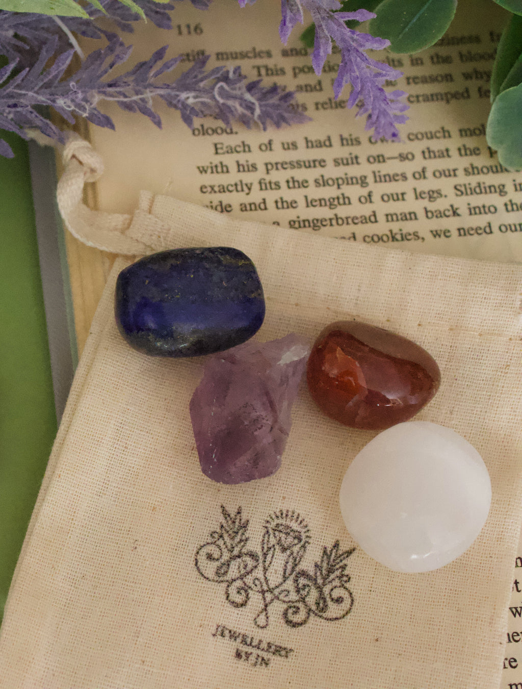 Close-up of tumbled gemstones from Health Gemstone Bag by Jewellery by JN, showing Carnelian, Amethyst, Selenite, and Lapis Lazuli.