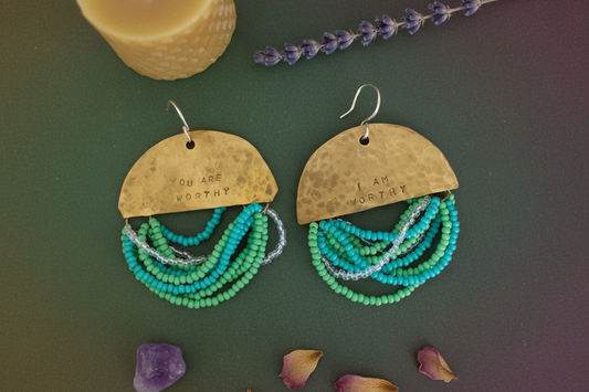 Half Moon Wordkeeper Earrings by Jewellery by JN, hand-hammered brass crescents with glass seed bead fringe and sterling silver ear wires, shown straight on.