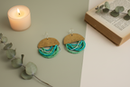 Half Moon Wordkeeper Earrings styled with ritual props, featuring brass, bead fringe, and silver, Jewellery by JN.