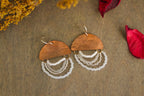 Close-up of Mini Wordkeeper Earrings Light by Jewellery by JN, highlighting textured copper, white and silver beadwork, and hand-stamped word LIGHT.