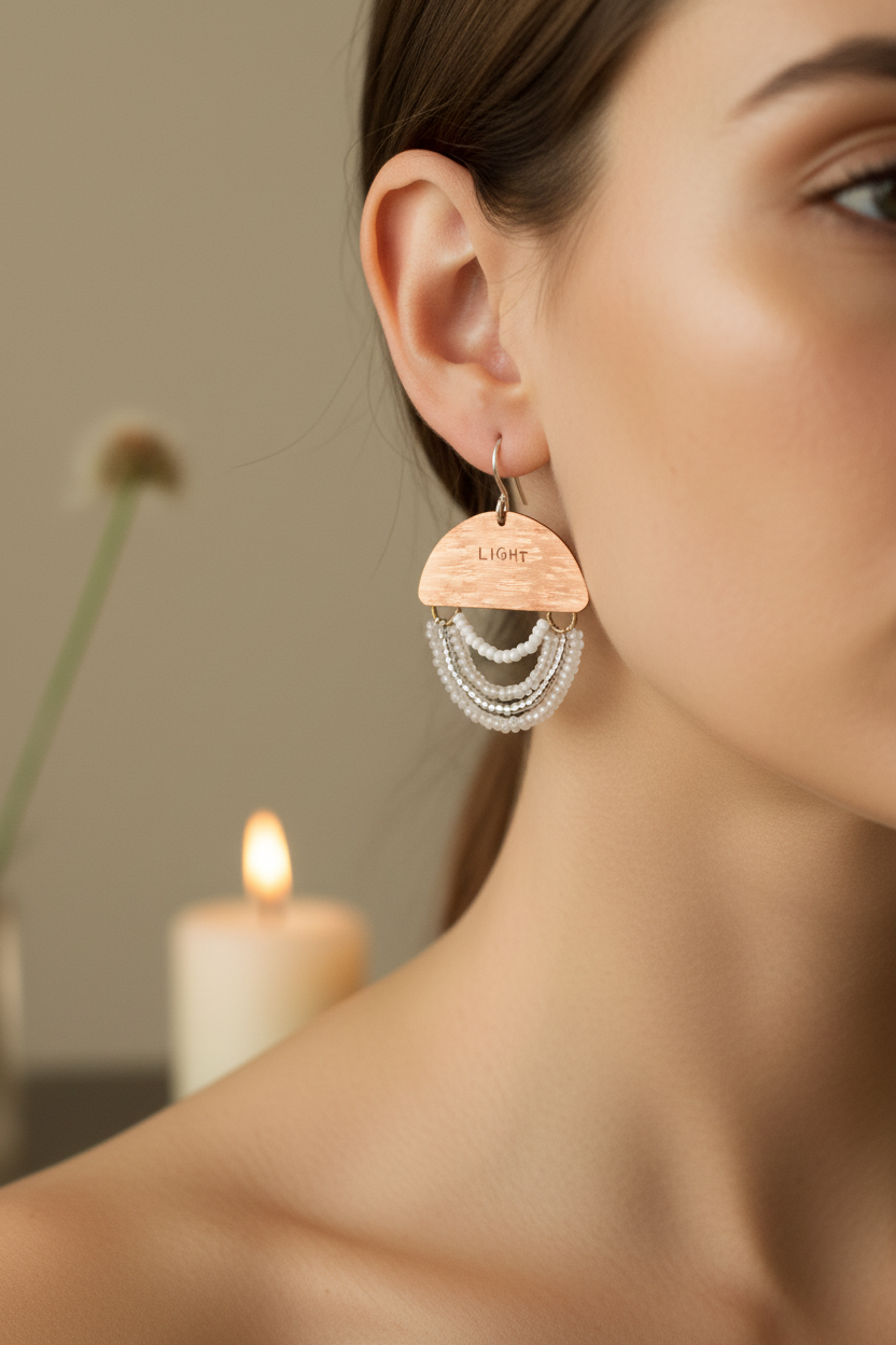 Woman wearing Mini Wordkeeper Earrings Light by Jewellery by JN, showing copper, white and silver bead fringe, and silver ear wires.