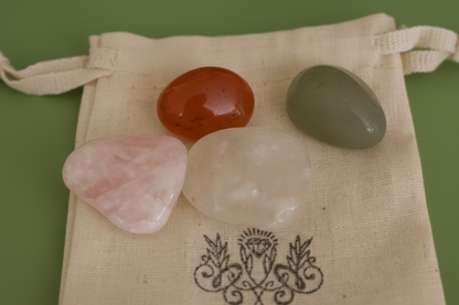 "Close-up of tumbled gemstones from Love Gemstone Bag by Jewellery by JN, showing Carnelian, Rose Quartz, Clear Quartz, and Green Aventurin