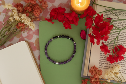 Obsidian Dawn Bracelet by Jewellery by JN, featuring amethyst, grey volcanic rock, and sterling silver beads, arranged in a flat lay on a neutral background."