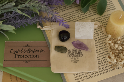 Protection Gemstone Bag by Jewellery by JN, recycled cotton pouch with tumbled Labradorite, Amethyst, Snowflake Obsidian, and Selenite, displayed on creamy linen with ritual props.
