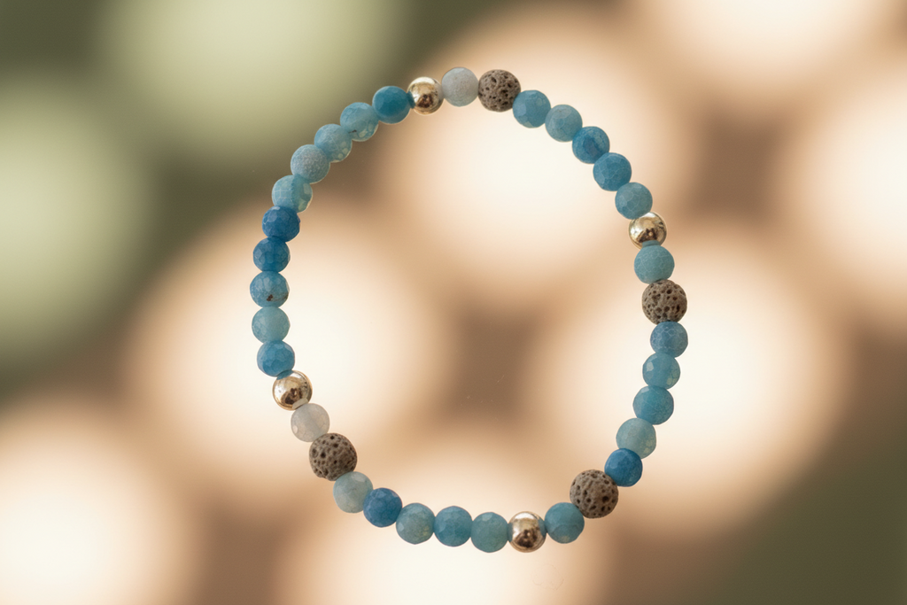 "Close-up of Shadowcurrent Bracelet by Jewellery by JN, highlighting the blue agate, volcanic rock, and sterling silver bead details."
