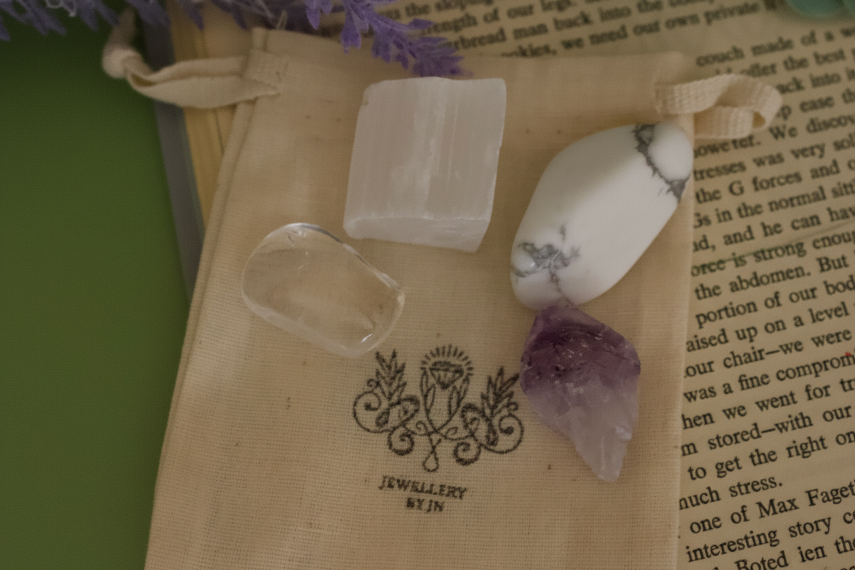Close-up of tumbled gemstones from Sleep Gemstone Bag by Jewellery by JN, showing Selenite, Clear Quartz, Amethyst, and Howlite.