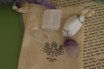 Close-up of tumbled gemstones from Sleep Gemstone Bag by Jewellery by JN, showing Selenite, Clear Quartz, Amethyst, and Howlite.