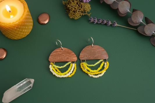 Mini Wordkeeper Earrings Transformation by Jewellery by JN, hand-forged copper with yellow and gold seed bead fringe and handmade sterling silver ear wires, shown front-facing.