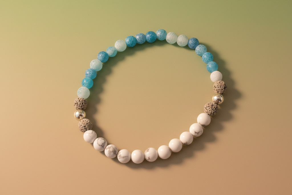 Close-up of Truthweaver Bracelet by Jewellery by JN, highlighting the blue agate, howlite, volcanic rock, and sterling silver bead details."
