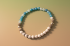 Close-up of Truthweaver Bracelet by Jewellery by JN, highlighting the blue agate, howlite, volcanic rock, and sterling silver bead details."
