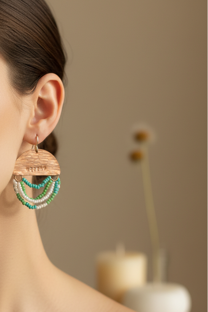 Woman wearing Mini Wordkeeper Earrings Worthy by Jewellery by JN, showing copper, green, teal, and white bead fringe, and silver ear wires.