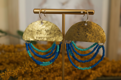 Close-up of Half Moon Wordkeeper Earrings Loved by Jewellery by JN, highlighting hammered brass, beadwork, and hand-stamped affirmations.