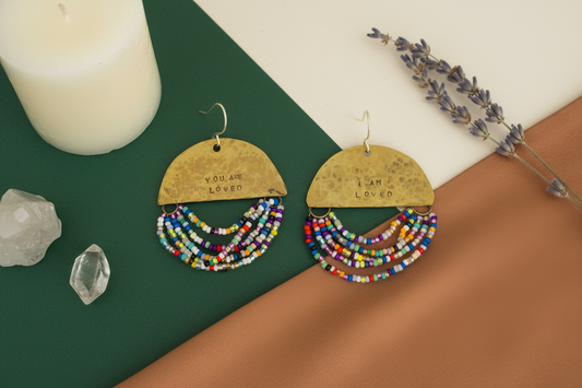 Half Moon Wordkeeper Earrings Loved by Jewellery by JN, hammered brass crescents with multicolour bead fringe and handmade sterling silver ear wires, shown front-facing.