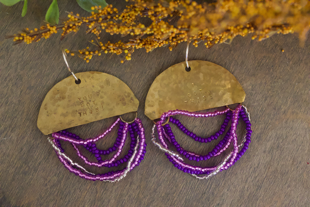Close-up of Half Moon Wordkeeper Earrings Got This by Jewellery by JN, highlighting hammered brass, beadwork, and hand-stamped affirmations.