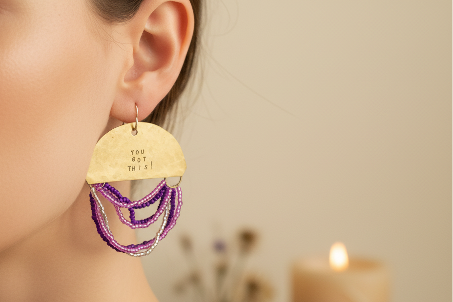 Woman wearing Half Moon Wordkeeper Earrings Got This by Jewellery by JN, showing brass crescents, colourful bead fringe, and silver ear wires.