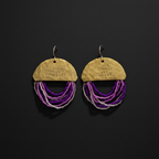 A pair of handmade dangle earrings on a dark background. Each earring features a hammered gold-tone semicircle top stamped with 'YOU GOT THIS!' and multiple strands of purple and silver beads hanging below.